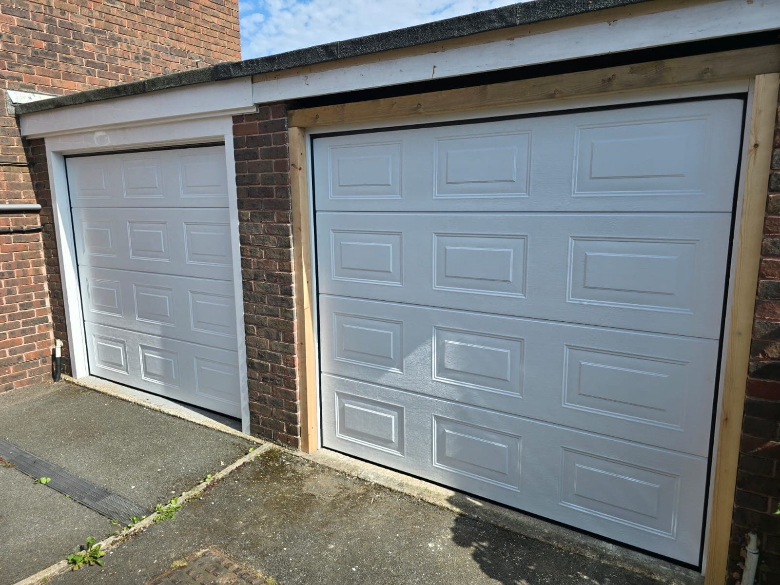 Twin sectional Georgian garage doors with automation and uPVC trim